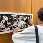 Visitatori che toccano un'opera della mostra inclusiva a Palazzo Lombardia