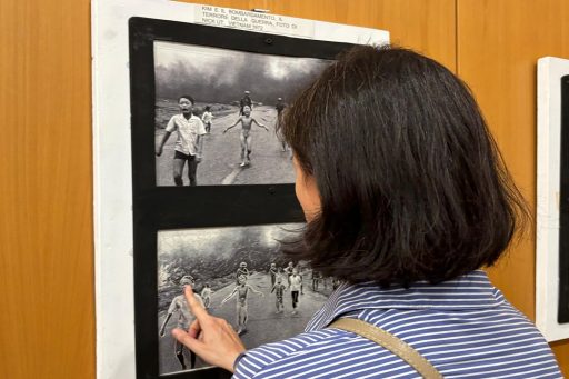 Un visitatore che tocca un'opera della mostra inclusiva a Palazzo Lombardia