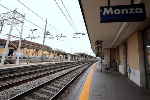 La foto ritrae il primo binario della stazione di Monza, mostrando i binari e la banchina vuota. In alto a destra il cartello 'Monza'. Foto usata per il protocollo d'intesa