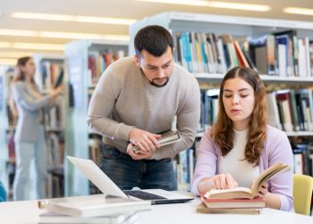 In foto due ragazzi in una biblioteca: da Regione Lombardia 290.000 euro come fondi per le biblioteche della Città metropolitana di Milano