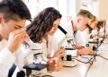 immagine di studenti con microscopio per dare l'idea del premio lombardia è ricerca studenti 2026