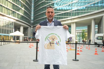 L'assessore Lucente in piazza Città di Lombardia mentre tiene in mano la maglia dell'Unione Italiana Ciechi e Ipovedenti per la Giornata dei cani guida