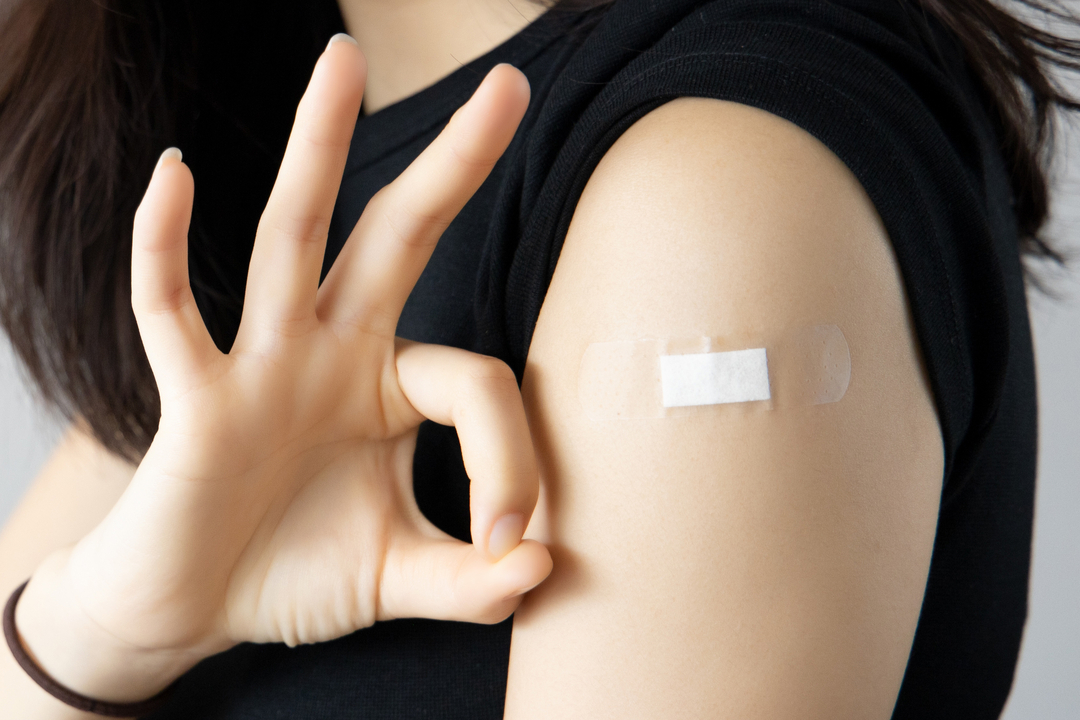 Vaccinazione antinfluenzale, la foto una donna dopo aver fatto il vaccino, con il cerotto e con la mano fa segno di 'ok'. Foto utilizzata per pezzo vaccinazioni antinfluenzali milione 2026